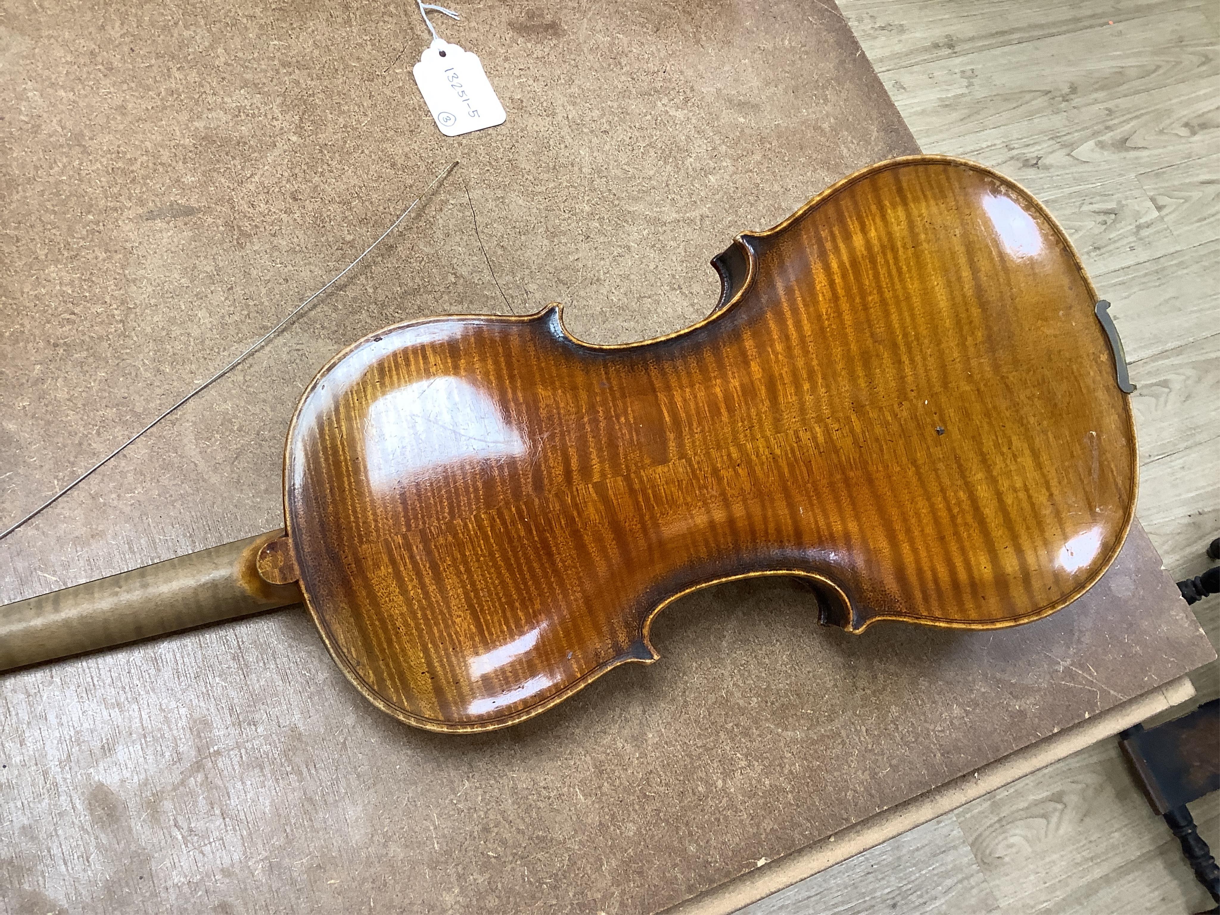 A cased 7/8 size 19th century violin, body 35cm, together with another cased violin, body 35.5cm, both without bows, and a spare case (3)